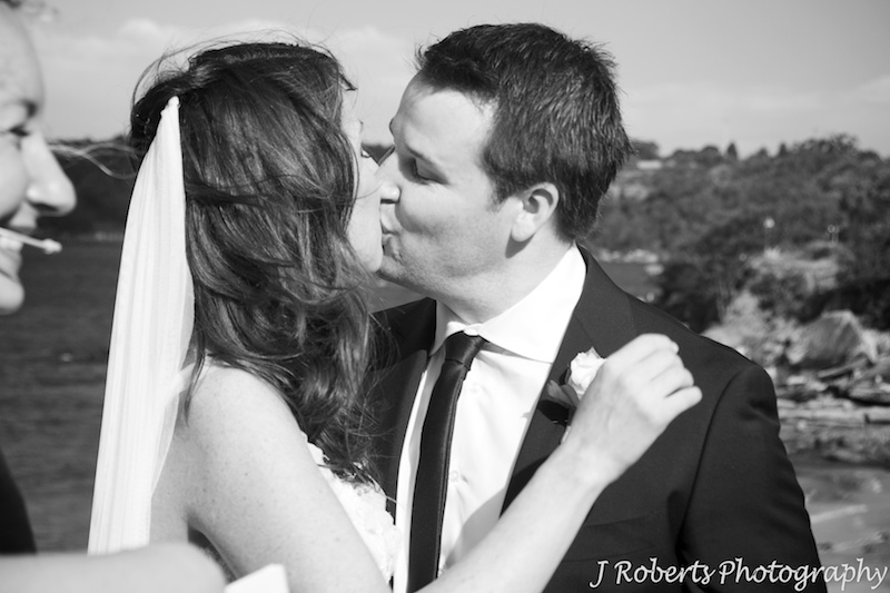 Bride and grooms first kiss on Bathers Pavilion Terrace Balmoral - wedding photography sydney